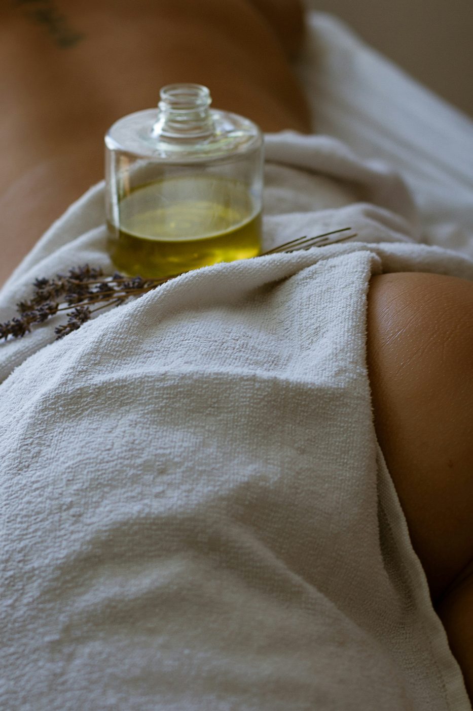Massageolie, håndklæde og tulipaner